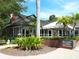 Charming building exterior with brick accents and mature trees at 707 S Gulfstream Ave # 301, Sarasota, FL 34236