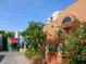 Charming building exterior with red flowers and lush landscaping at 707 S Gulfstream Ave # 301, Sarasota, FL 34236