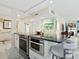 Contemporary kitchen island with stainless appliances, granite countertops, and breakfast bar seating at 707 S Gulfstream Ave # 301, Sarasota, FL 34236