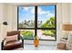 Living room featuring a water view from a large window, desk, modern decor, and tile floors at 707 S Gulfstream Ave # 301, Sarasota, FL 34236