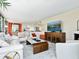 Bright living room featuring large windows, a fireplace, and open concept to kitchen at 707 S Gulfstream Ave # 301, Sarasota, FL 34236