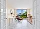 Living room with marble floors, modern furnishings, and a beautiful water view from a large window at 707 S Gulfstream Ave # 301, Sarasota, FL 34236