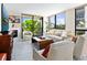 Bright living room featuring large windows, a fireplace, and views of lush greenery at 707 S Gulfstream Ave # 301, Sarasota, FL 34236