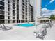 Community swimming pool surrounded by lounge chairs and modern architecture at 707 S Gulfstream Ave # 301, Sarasota, FL 34236