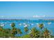 Beautiful bay view dotted with sailboats and palm trees creating a serene scene at 707 S Gulfstream Ave # 301, Sarasota, FL 34236
