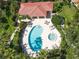 Aerial view of community pool and hot tub surrounded by lounge chairs and lush landscaping at 7331 Villa D Este Dr, Sarasota, FL 34238