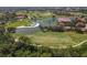 Stunning aerial view of the golf course community with lush landscaping and serene lake views at 7331 Villa D Este Dr, Sarasota, FL 34238