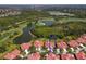 Gorgeous aerial shot of the house, showing golf course, lake and greenery at 7331 Villa D Este Dr, Sarasota, FL 34238
