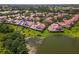 Beautiful aerial view of the home with a serene pond and lush landscaping at 7331 Villa D Este Dr, Sarasota, FL 34238