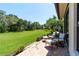 Expansive backyard view featuring a well-manicured lawn and comfortable seating area at 7331 Villa D Este Dr, Sarasota, FL 34238