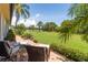 Beautiful backyard view with manicured lawn, lush landscaping, and a view of the water at 7331 Villa D Este Dr, Sarasota, FL 34238