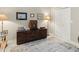Neutral bedroom featuring a decorative console table with vintage decor and soft, patterned rug at 7331 Villa D Este Dr, Sarasota, FL 34238