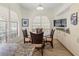 Charming breakfast nook featuring a round glass table, four chairs, and a large window at 7331 Villa D Este Dr, Sarasota, FL 34238