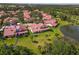 Lush backyard views showing mature landscaping, red tile roof, and serene atmosphere at 7331 Villa D Este Dr, Sarasota, FL 34238
