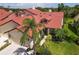 Lovely home showcasing a red tile roof and verdant landscaping at 7331 Villa D Este Dr, Sarasota, FL 34238