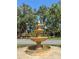 Community fountain surrounded by lush greenery at 7331 Villa D Este Dr, Sarasota, FL 34238