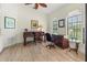 Bright home office featuring a wooden desk, decorative art, and tile floors at 7331 Villa D Este Dr, Sarasota, FL 34238