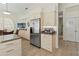 Modern kitchen featuring stainless steel appliances, cream cabinetry, and natural light at 7331 Villa D Este Dr, Sarasota, FL 34238