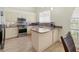 Bright kitchen featuring stainless steel appliances, granite countertops, and white cabinetry at 7331 Villa D Este Dr, Sarasota, FL 34238