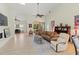 Bright and airy living room featuring comfortable seating, a ceiling fan, and access to outdoor living spaces at 7331 Villa D Este Dr, Sarasota, FL 34238