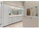 Bright main bathroom showcasing dual sinks, custom cabinetry, and glass enclosed shower at 7331 Villa D Este Dr, Sarasota, FL 34238