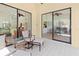 Relaxing patio with comfortable seating, tiled flooring, and beautiful views of the living area at 7331 Villa D Este Dr, Sarasota, FL 34238