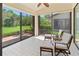 Bright sunroom with tile flooring, comfortable seating, and scenic backyard views at 7331 Villa D Este Dr, Sarasota, FL 34238