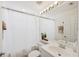 Clean and bright bathroom with vanity, toilet, and shower with a curtain at 7532 Marsh Orchid Cir # 8-201, Bradenton, FL 34203