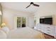 Relaxing bedroom with dresser, TV, and a balcony with scenic views at 7532 Marsh Orchid Cir # 8-201, Bradenton, FL 34203