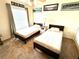Comfortable bedroom with ceiling fan, two twin beds, and simple decor at 7532 Marsh Orchid Cir # 8-201, Bradenton, FL 34203