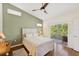 Bright bedroom with a ceiling fan and a balcony with views at 7532 Marsh Orchid Cir # 8-201, Bradenton, FL 34203
