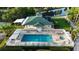 Aerial view of an exquisite community pool with ample seating and meticulous landscaping at 7532 Marsh Orchid Cir # 8-201, Bradenton, FL 34203