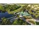 Beautiful golf course and clubhouse surrounded by trees and a serene pond at 7532 Marsh Orchid Cir # 8-201, Bradenton, FL 34203