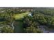 Picturesque golf course with winding path, lush greenery, and a serene pond at 7532 Marsh Orchid Cir # 8-201, Bradenton, FL 34203