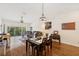 Open-concept living and dining room with hardwood floors and views to the balcony at 7532 Marsh Orchid Cir # 8-201, Bradenton, FL 34203