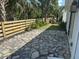 This home includes a backyard patio with stone floors and a wooden fence for added privacy at 754 Spanish S Dr # 754, Longboat Key, FL 34228
