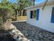 Quaint backyard featuring a stone-paved area, wooden fence, and lush green foliage at 754 Spanish S Dr # 754, Longboat Key, FL 34228
