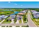 Aerial view of a lakeside suburban community featuring manicured lawns and modern homes at 8272 Summer Night Rd, Sarasota, FL 34241