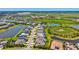 Expansive aerial shot of an attractive community with a pond and modern homes with manicured lawns at 8272 Summer Night Rd, Sarasota, FL 34241