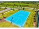 Vibrant blue basketball court surrounded by lush greenery, offering an active lifestyle within the community at 8272 Summer Night Rd, Sarasota, FL 34241