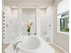 Bright bathroom features a large soaking tub and a large window at 8272 Summer Night Rd, Sarasota, FL 34241