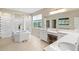 Bright bathroom featuring double sinks, large soaking tub and walk-in shower at 8272 Summer Night Rd, Sarasota, FL 34241
