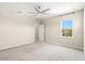 Bright, airy bedroom with neutral carpet, ceiling fan, and a large window at 8272 Summer Night Rd, Sarasota, FL 34241