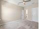 Neutral carpeted bedroom with ceiling fan and two doors at 8272 Summer Night Rd, Sarasota, FL 34241
