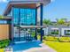 Striking view of a modern clubhouse featuring a glass facade, clean lines, and lush landscaping at 8272 Summer Night Rd, Sarasota, FL 34241