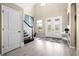 Welcoming foyer with high ceilings, elegant staircase, and double front doors, creating a grand entrance at 8272 Summer Night Rd, Sarasota, FL 34241