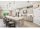 Bright kitchen features an island with bar seating, stainless steel appliances, and stylish pendant lighting at 8272 Summer Night Rd, Sarasota, FL 34241