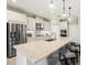 Well-lit kitchen showcases stainless steel appliances, a large island with seating, and ample cabinet space at 8272 Summer Night Rd, Sarasota, FL 34241