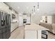 Modern kitchen features stainless steel appliances, a large island with seating, and open access to living space at 8272 Summer Night Rd, Sarasota, FL 34241