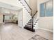 Open-concept living area featuring a staircase, and seamless flow into the adjacent living spaces at 8272 Summer Night Rd, Sarasota, FL 34241